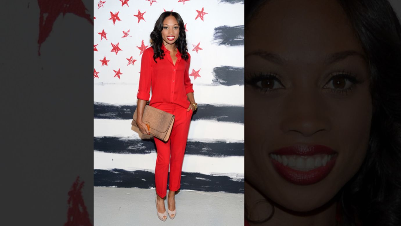 Allyson Felix, who won gold at the 2012 Olympics in the 200-meter sprint and the 4x100 and 4x400 relays, poses in front of stars and stripes at the Alice + Olivia by Stacey Bendet presentation.