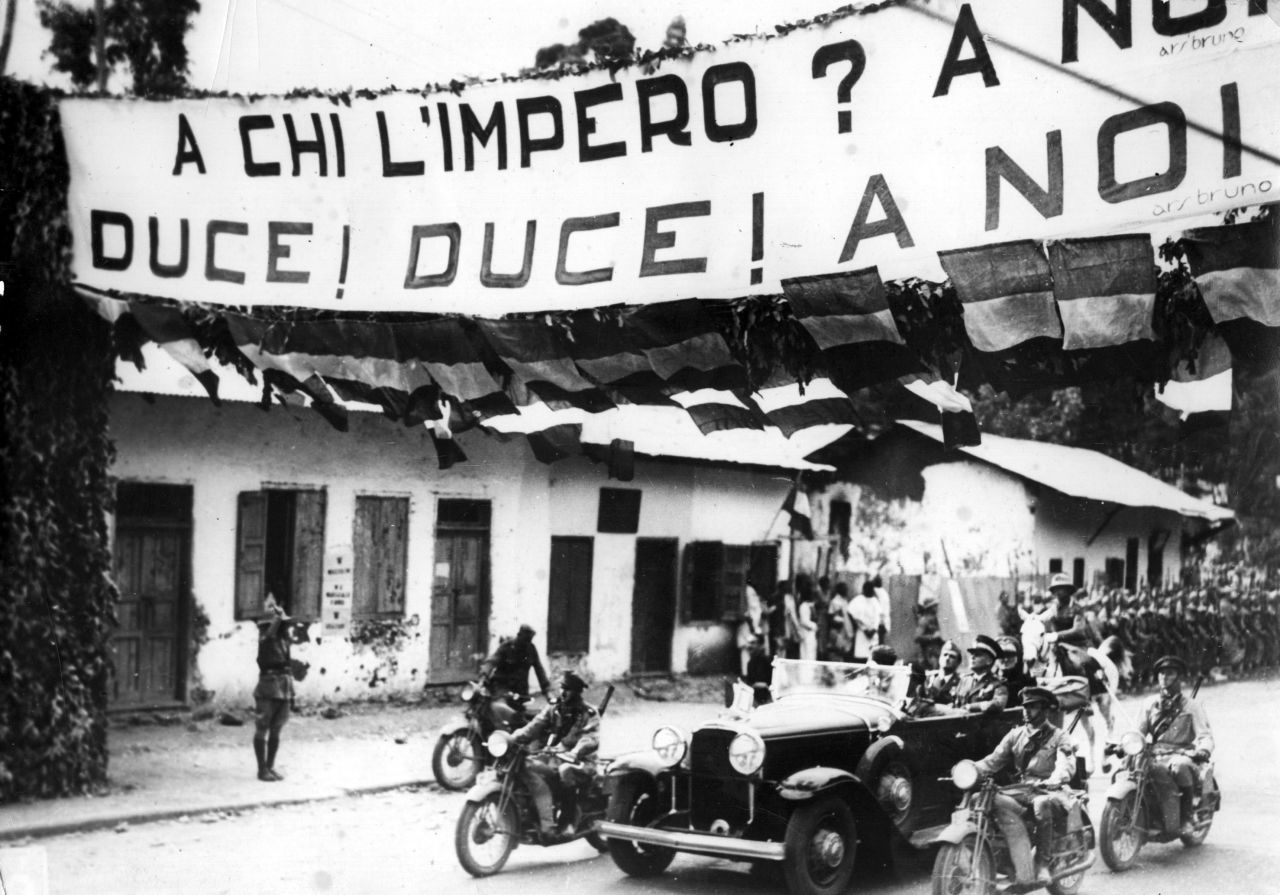 Despite an emotional appeal by Ethiopian emperor Haile Selassie, the League of Nations lifts sanctions against Italy on July 4, 1936. A banner in Italian-occupied Addis Ababa, pictured, reads: "To whom does the empire belong? Duce! Duce! To ourselves!"