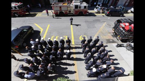 The firefighters of New York City's Engine 33-Ladder 9 observe a moment of silence on Tuesday.  The company lost 10 firefighters in the 9/11 attacks.