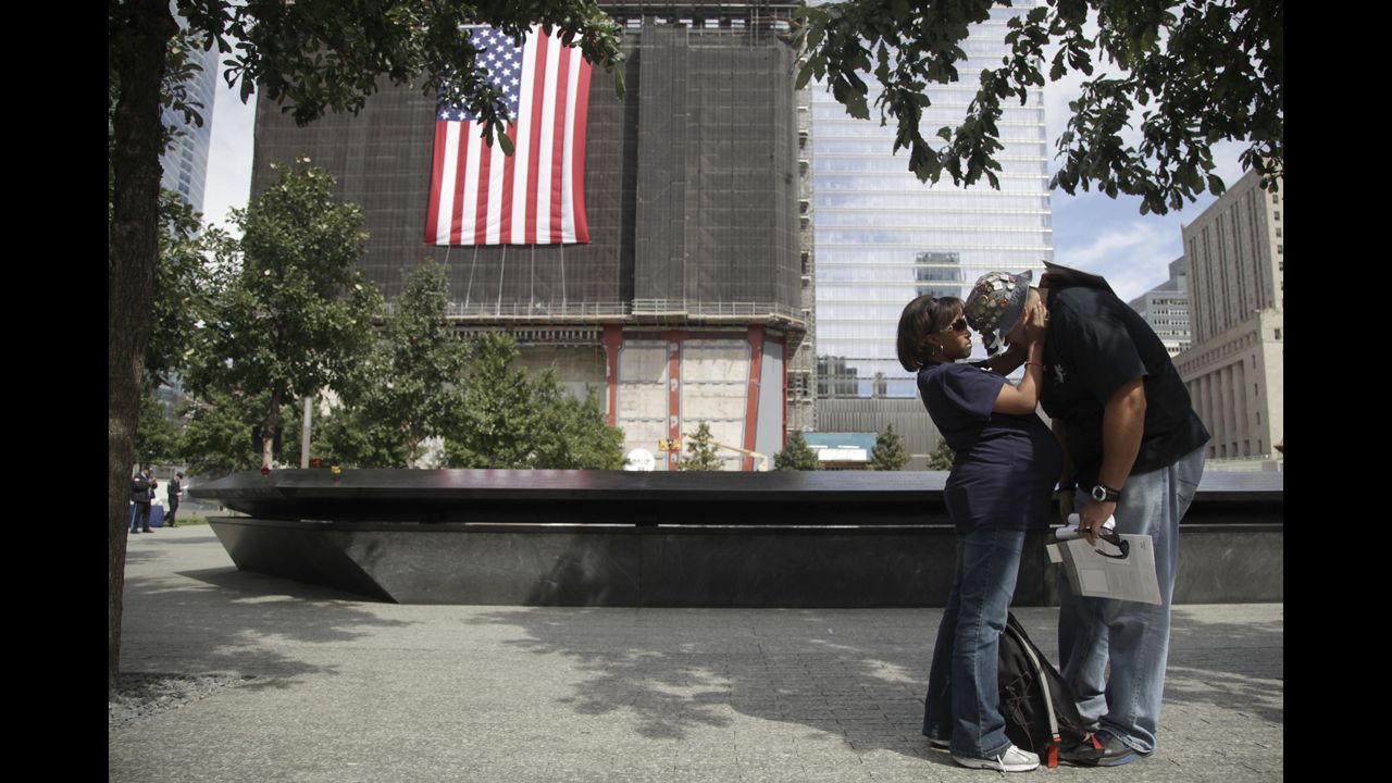 Jillian Suarez, left, consoles Eloy Suarez during observances of the anniversary of the 9/11 attacks on Tuesday.