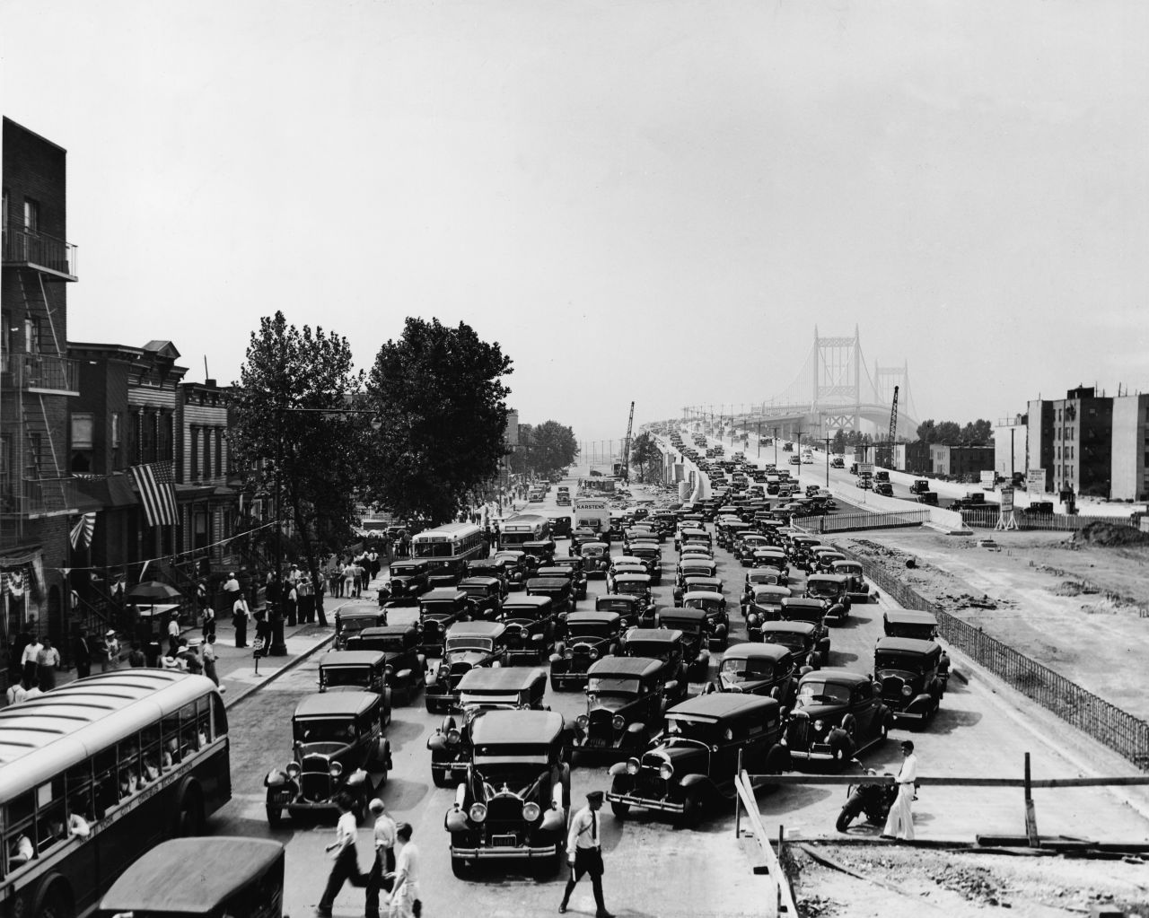 The Triborough Bridge linking Manhattan, Bronx and Queens opens in New York City on July 11, 1936. Pictured here are cars exiting the bridge in Harlem.