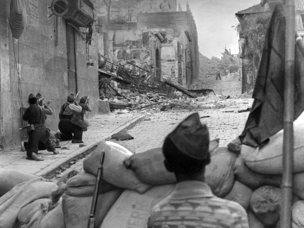 The Spanish Civil War breaks out on July 17, 1936. Pictured are Republicans battling for the Alcazar in Toledo where rebels, ultimately saved by troops under Francisco Franco, were sheltered.