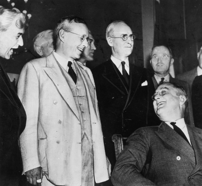 U.S. President Franklin Delano Roosevelt, seated at right, is re-elected on November 3, 1936, in a landslide victory over Kansas Governor Alfred Landon, pictured greeting him.