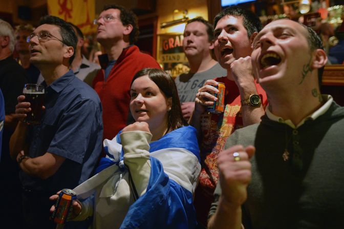 Fans of tennis player Andy Murray react as they watch his U.S. Open men's singles final match against Novak Djokovic in the bar of The Dunblane Hotel on Monday in his hometown of Dunblane, Scotland.
