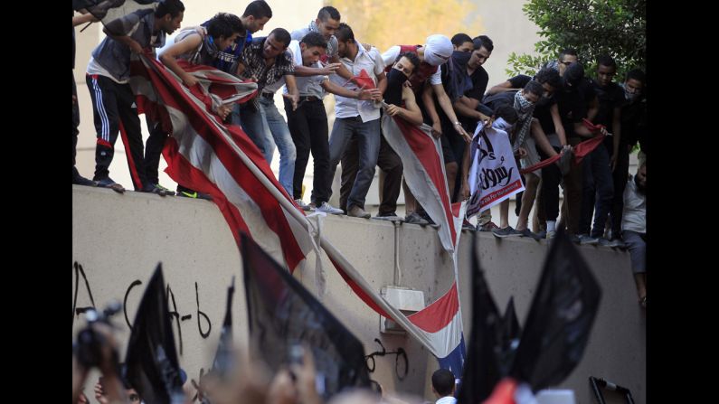 Protesters destroy an American flag pulled down from the U.S. Embassy in Cairo, Egypt.