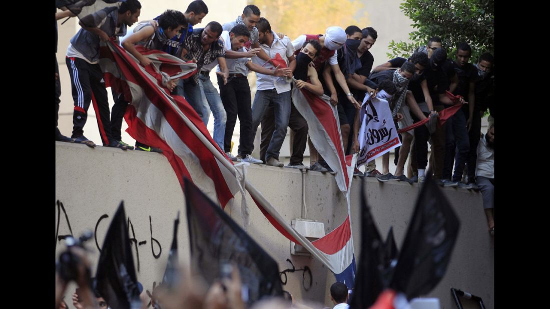 Protesters destroy an American flag pulled down from the U.S. Embassy in Cairo, Egypt.