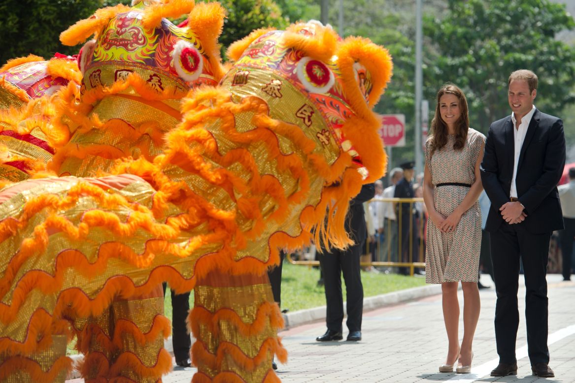 Prince William, right, and wife Catherine are welcomed by a lion dance performance on Wednesday.
