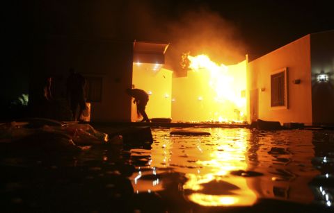 People duck flames outside a building on September 11.