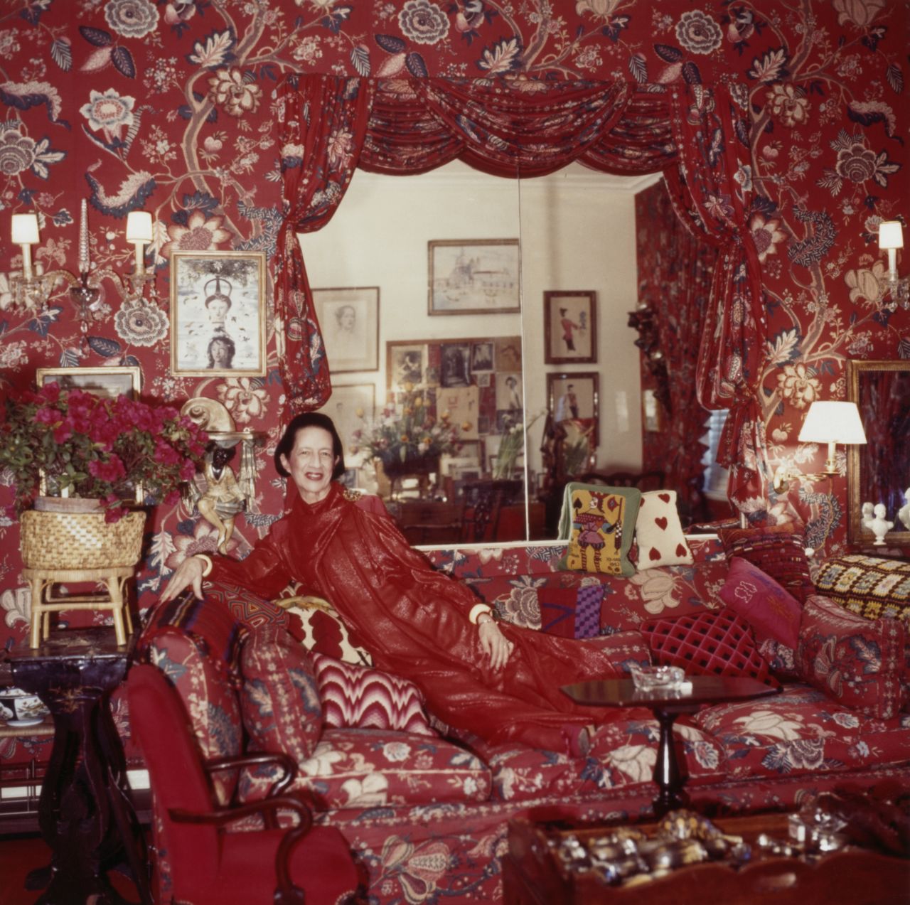 Diana Vreeland in her famous red living room, nicknamed "a garden in hell."