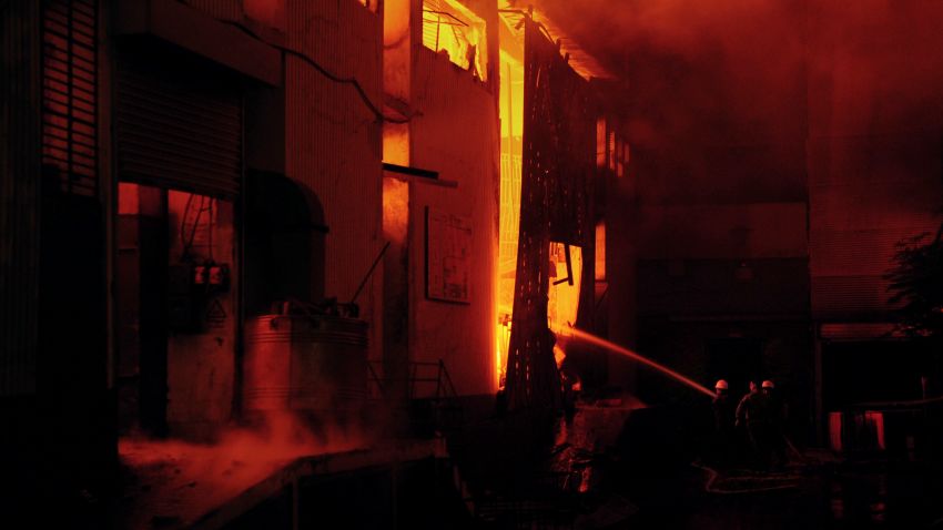 Pakistani firefighters extinguish a fire that erupted in a garment factory in Karachi. 