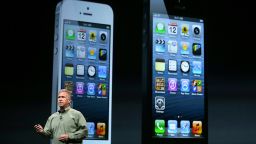 Apple marketing chief Phil Schiller with a slide showing black and white models of the new iPhone 5.