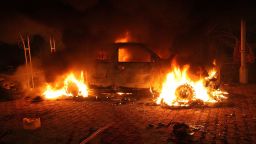 A vehicle and the surrounding area are engulfed in flames after it was set on fire inside the compound on Tuesday.