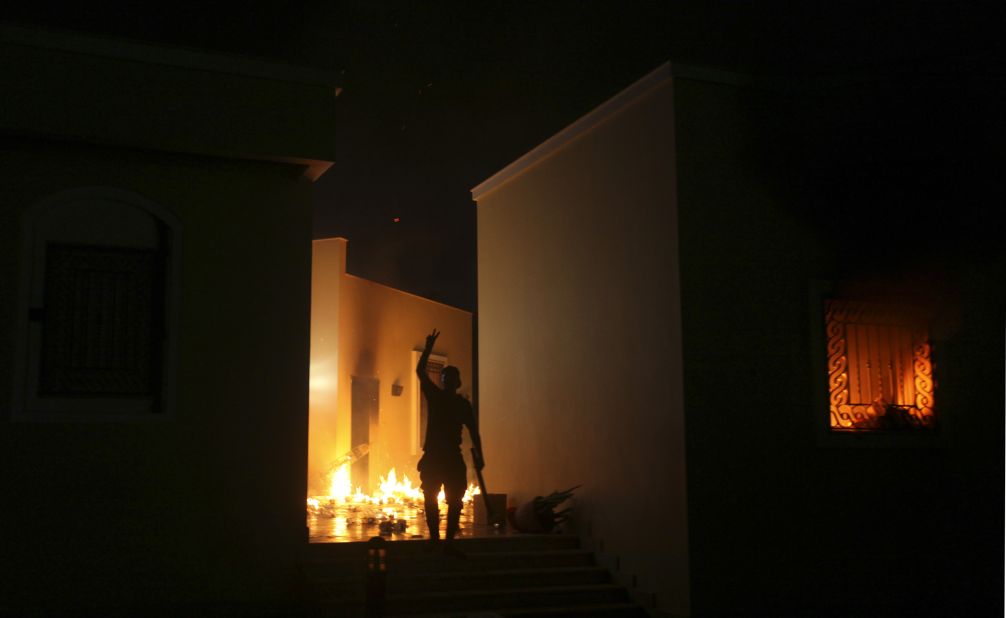 A protester reacts as the U.S. Consulate in Benghazi is seen in flames Tuesday night. 