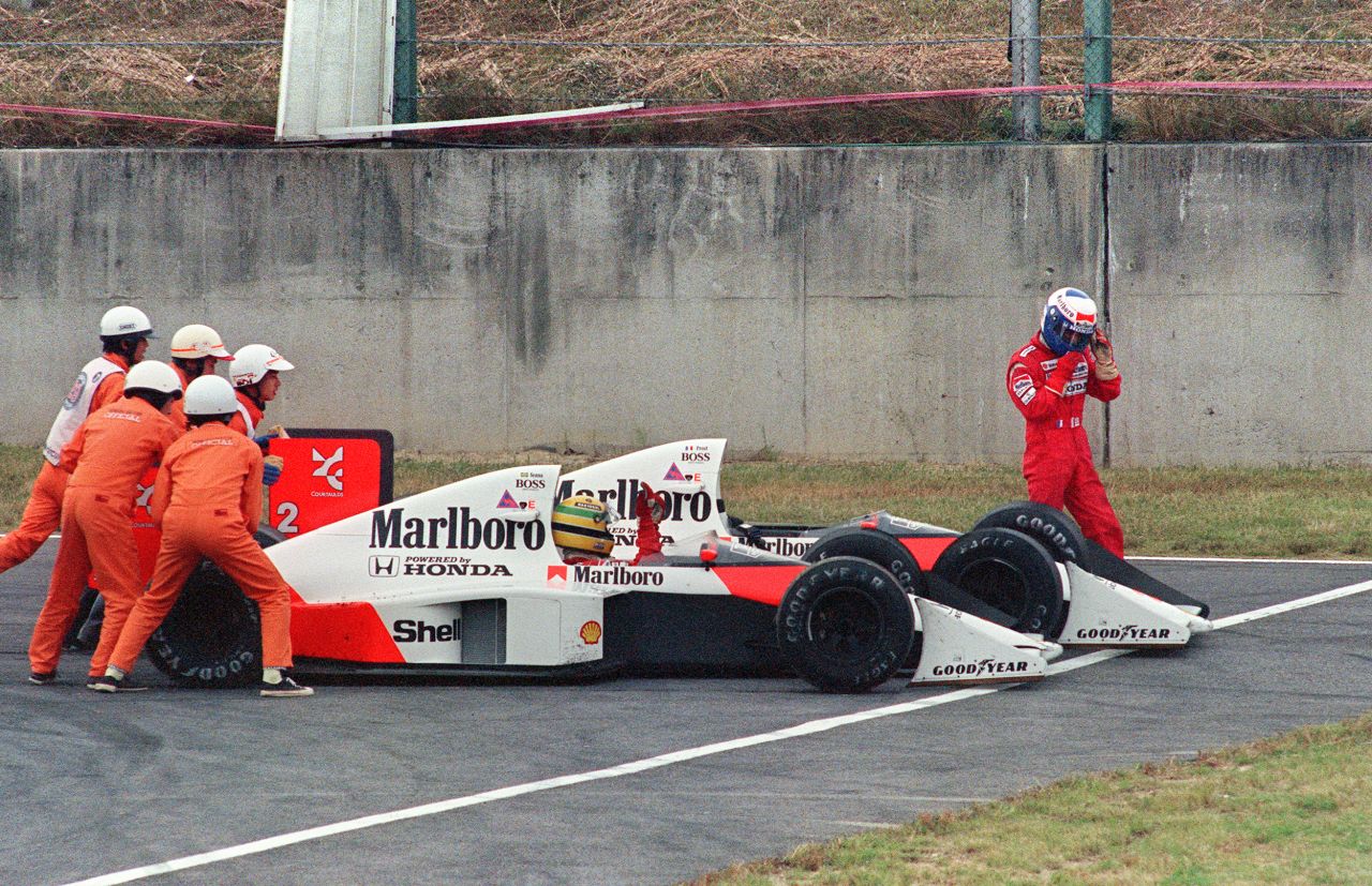 Senna is given a push for a restart while Prost abandons the race after the supposed teammates collided during the Japanese Grand Prix in 1989.