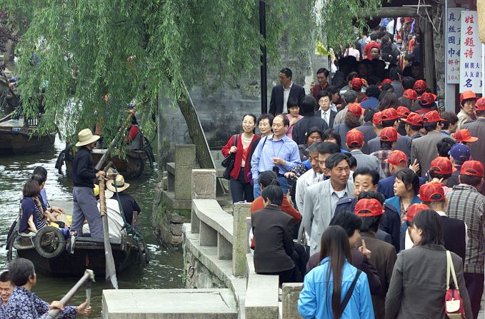 Then follow many of China's own tourists to the water village of Zhou Zhuang.