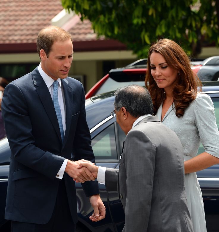 Britain's Prince William and his wife, Catherine, meet Richard Robless, council member of Hospis Malaysia, in Kuala Lumpur on Thursday.