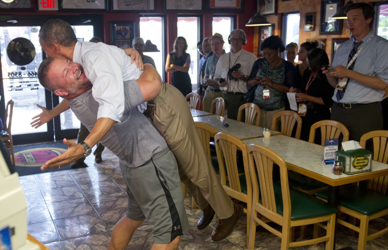 Obama is lifted up by Scott Van Duzer, owner of Big Apple Pizza and Pasta Italian Restaurant, during a visit to the restaurant in Fort Pierce, Florida, on Sunday, September 9. Obama was on a two-day bus tour across the state.