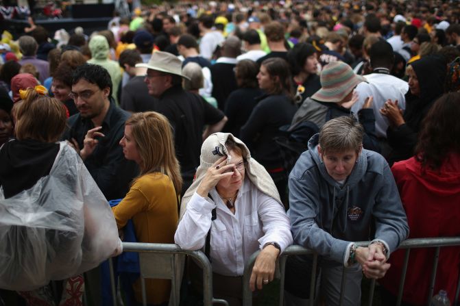 Supporters try to stay dry in between rain showers while waiting for President Obama to speak at the University of Iowa on Friday. It was Obama's first day of campaigning after accepting the presidential nomination at the Democratic National Convention in Charlotte, North Carolina.