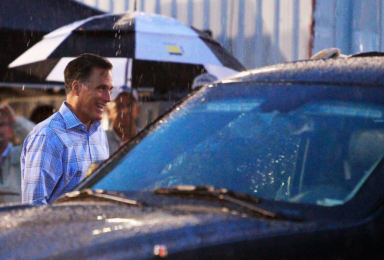Mitt Romney walks through the garage area during a rain delay before the start of the NASCAR Sprint Cup Series Federated Auto Parts 400 at Richmond International Raceway on Saturday, September 8, in Richmond, Virginia.  