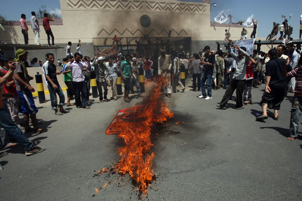 Yemeni protesters gather around a fire Thursday during a demonstration outside the U.S. Embassy in the capital of Sanaa. Yemeni forces fired warning shots to disperse the thousands of protesters approaching the main gate of the mission.