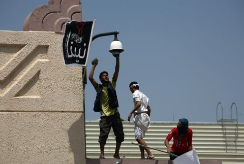 Yemeni protesters try to break the security camera at the U.S. Embassy in Sanaa on Thursday.