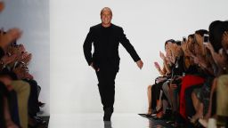Designer Michael Kors appears at the end of his show during New York fashion week on September 12, 2012.