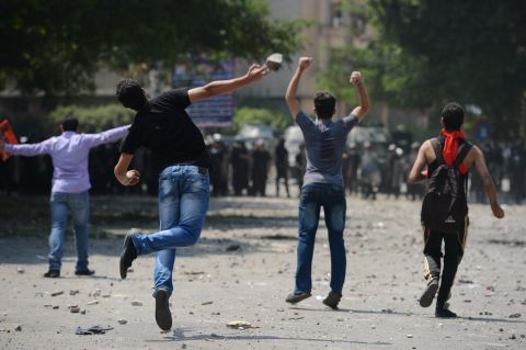 Egyptian protesters clash with riot police Thursday near the U.S. Embassy in Cairo.