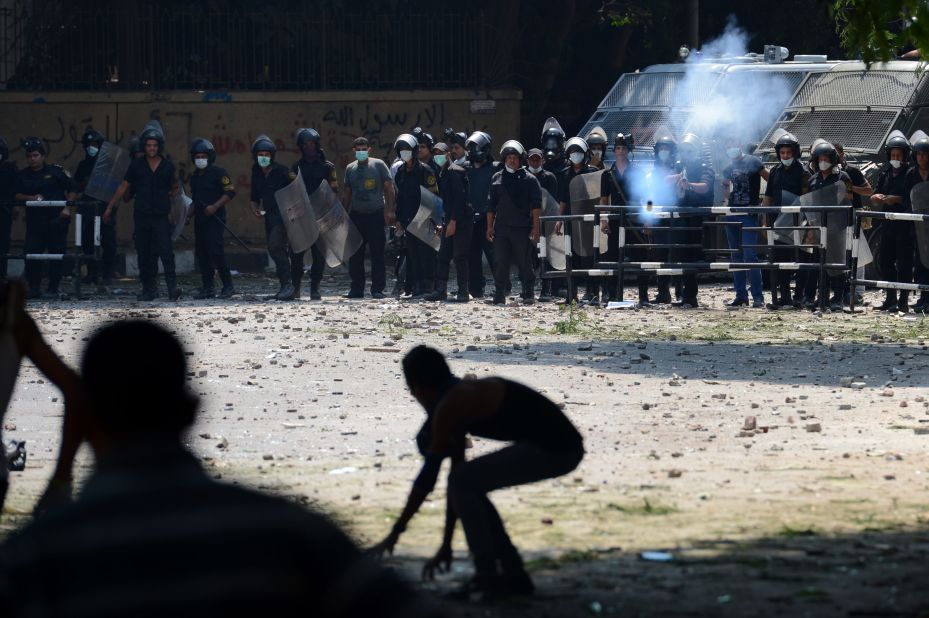 An Egyptian riot police officer fires tear gas toward protesters during clashes Thursday with police near the U.S. Embassy in Cairo. 
