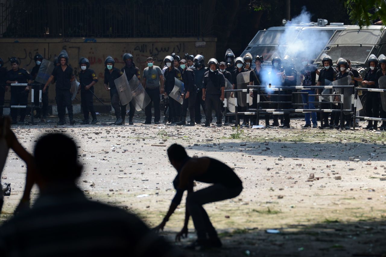 An Egyptian riot police officer fires tear gas toward protesters during clashes Thursday with police near the U.S. Embassy in Cairo.
