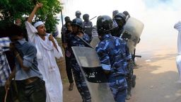Sudanese policemen try to disperse protesters demonstrating against an amateur film mocking Islam outside the German embassy in Khartoum on September 14, 2012.