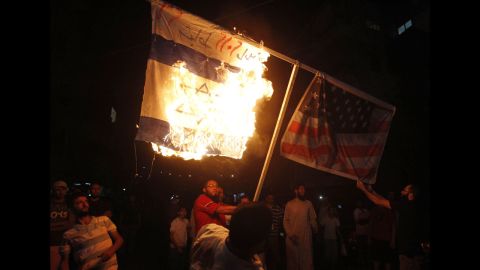 Supporters of Sunni Muslim Salafist leader Ahmad al-Assir burn Israeli and U.S. flags during a protest in Sidon, Lebanon, on Thursday.