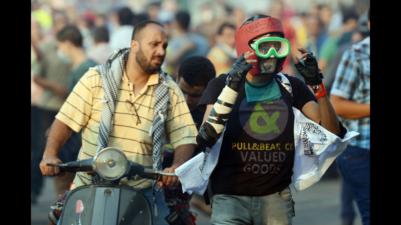 An Egyptian protester wears a makeshift mask and helmet for protection while fighting riot police on Thursday.