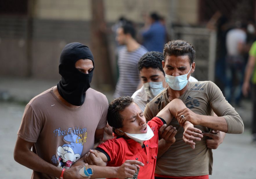 Egyptian protesters help a man who inhaled tear gas during clashes at the U.S. Embassy in Cairo on Thursday.