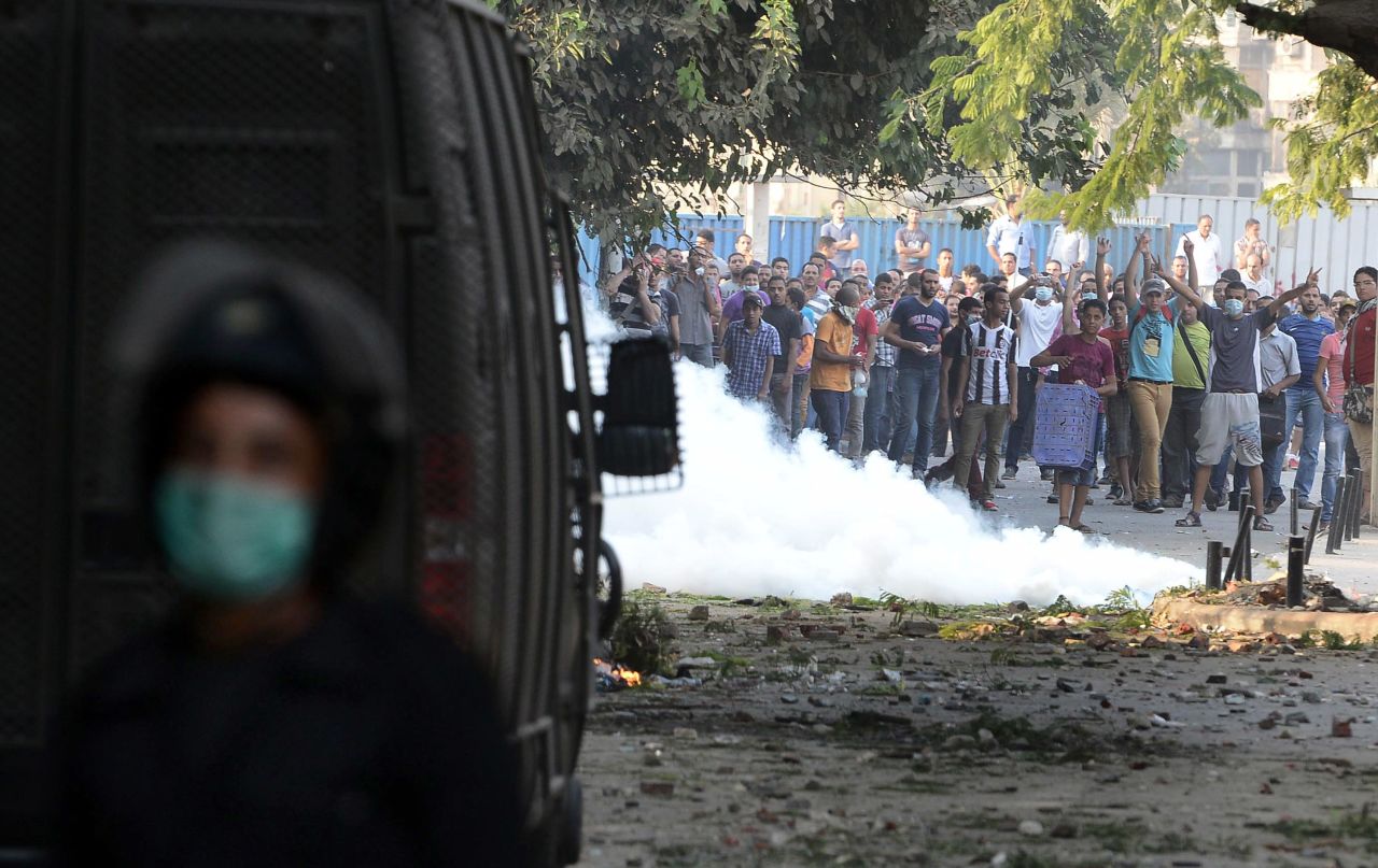 Egyptian protesters throw stones at riot police during clashes near the U.S. Embassy in Cairo on Thursday.