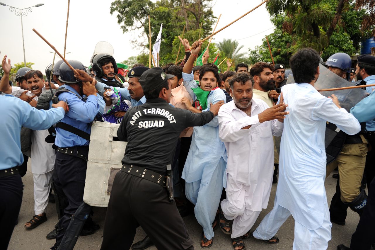 Pakistani soldiers hold back protesters attempting to reach the U.S. Embassy in Islamabad on Friday.
