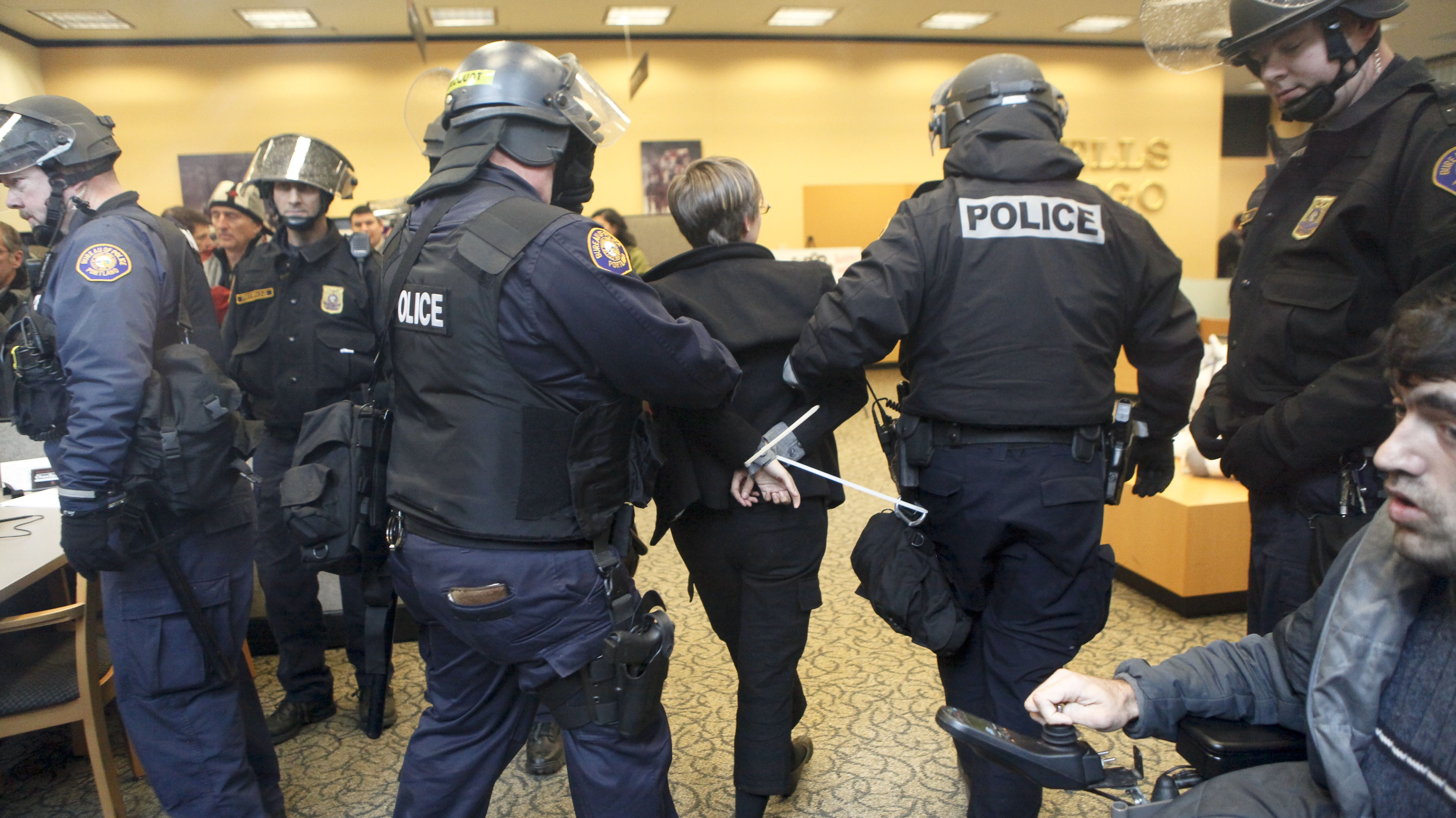 Portland Police arrest a demonstrator inside a Wells Fargo Bank branch November 17, 2011, in Portland, Oregon. 