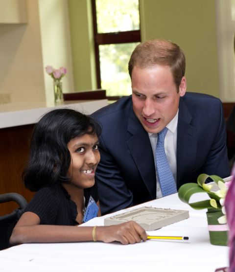 Britain's Prince William speaks with Linges Warry Apparad, a 14-year-old with leukemia, at Hospis Malaysia Thursday in Kuala Lumpur, Malaysia.