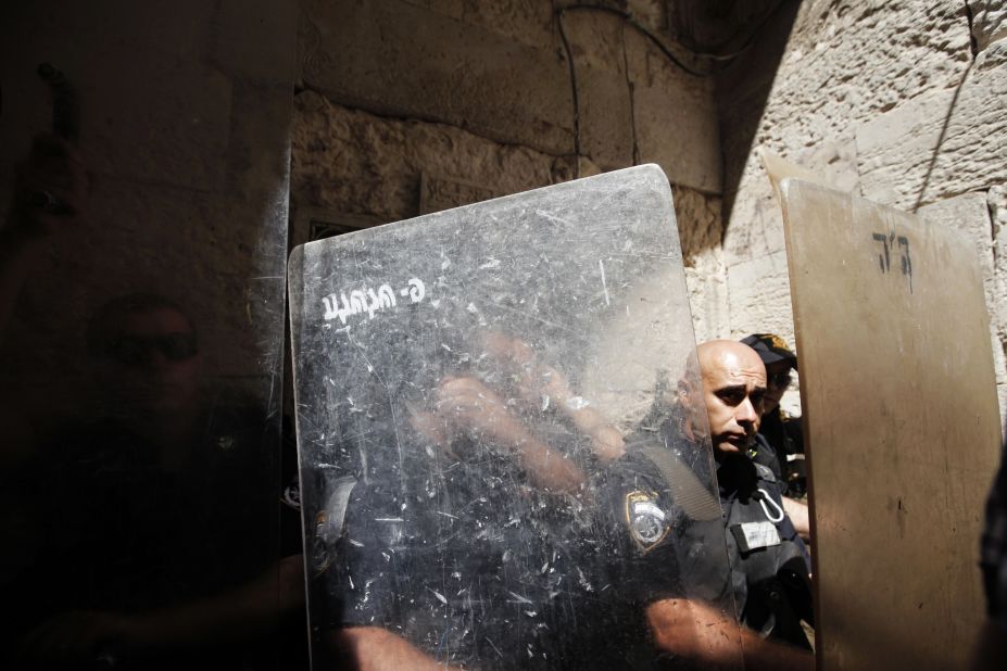 Israeli police officers stand behind their shields during clashes with stone-throwing Palestinian protesters in a demonstration against an anti-Islam film in front of the Dome of the Rock in Jerusalem's Old City on Friday.