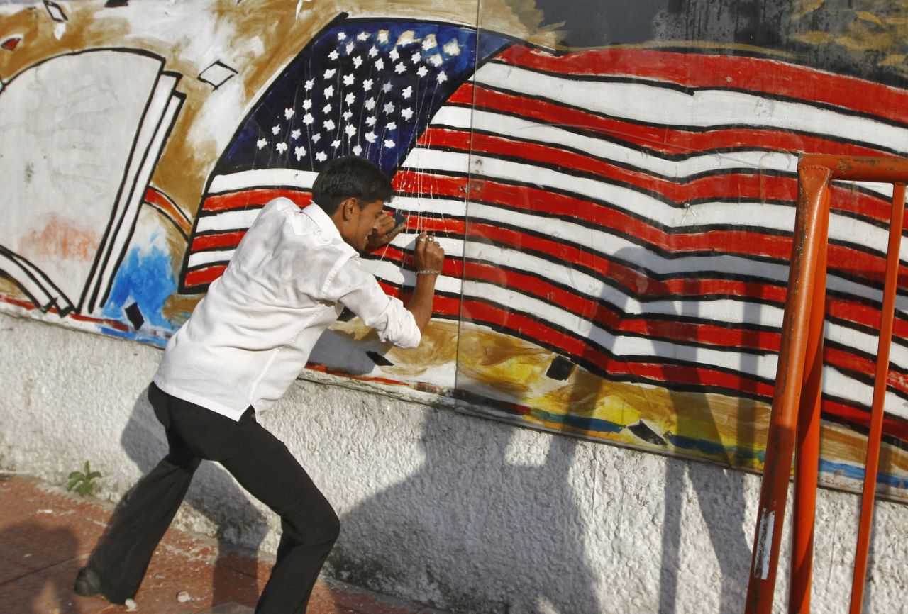 A Muslim protester defaces a mural on a wall of the U.S. Consulate in the southern Indian city of Chennai on Friday.