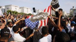 Tunisian protesters burn a US flag protesting against a film deemed offensive to Islam, outside the US embassy in Tunis on September 12, 2012.