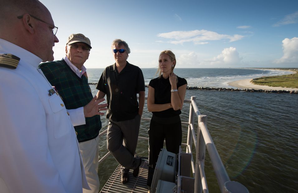 From left to right: Navy chaplain, Capt. Donald P. Troast, left, talks with Dean Armstrong, brother of the late Neil Armstrong, Eric "Rick" Armstrong, Neil Armstrong's son, and Molly Van Wagenen, Neil Armstrong's stepdaughter, from the top of the Navy ship as it departs from Mayport, Florida, a for the service.