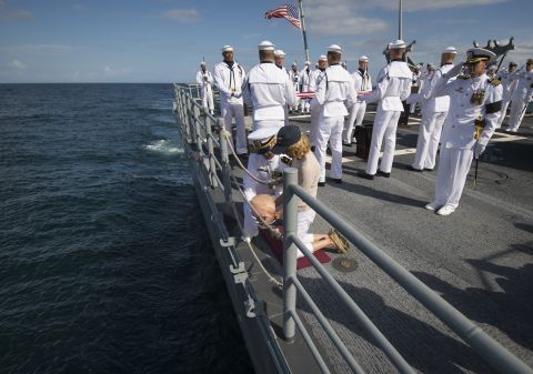 U.S. Navy Lt. Cmdr. Paul Nagy and Carol Armstrong, wife of Neil Armstrong, drop the remains of Neil Armstrong in the Atlantic Ocean.