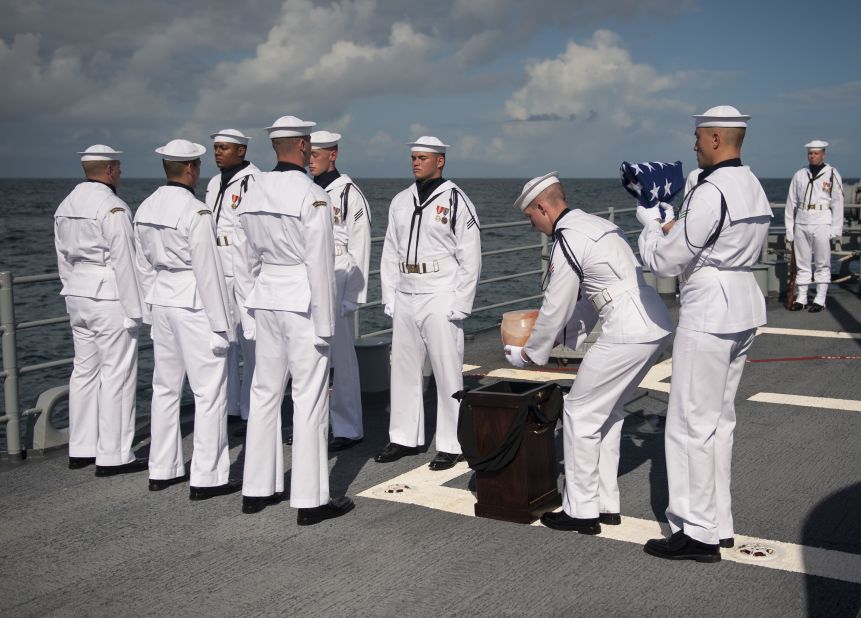 U.S. Navy personnel carry the remains of Apollo 11 astronaut Neil Armstrong during a burial at sea service aboard the USS Philippine Sea on Friday, September 14, in the Atlantic Ocean. Armstrong, the first man to walk on the moon on the Apollo 11 mission in 1969 died August 25 at age 82.  