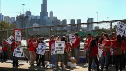 : 	CHICAGO, IL - SEPTEMBER 10: Chicago public school teachers picket on an overpass near downtown on September 10, 2012 in Chicago, Illinois. More than 26,000 teachers and support staff hit the picket lines this morning after the Chicago Teachers Union failed to reach an agreement with the city on compensation, benefits and job security. With about 350,000 students, the Chicago school district is the third largest in the United States. (Photo by Scott Olson/Getty Images) 