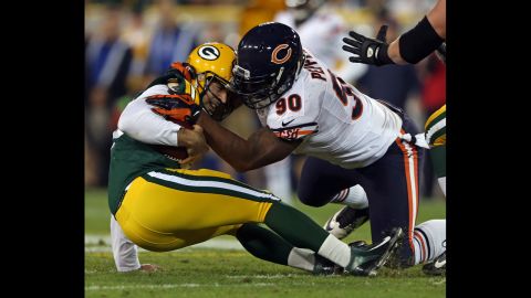 Chicago Bears defensive end Julius Peppers sacks Green Bay Packers quarterback Aaron Rodgers in the first quarter Thursday.