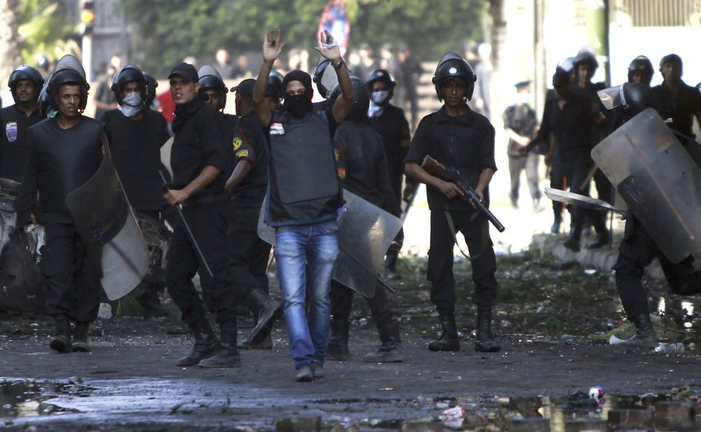 A riot police officer shouts a warning during clashes in Cairo on Friday. 