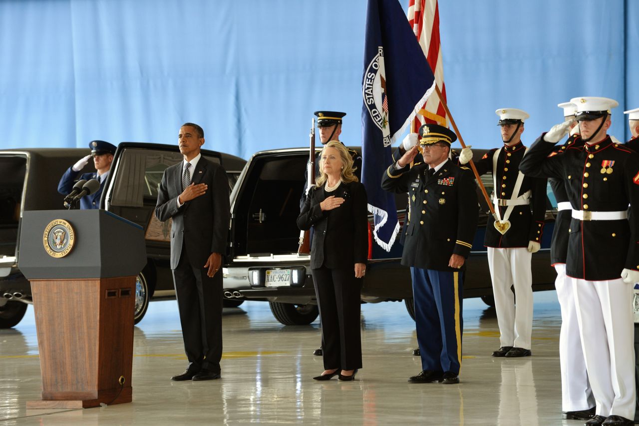 Obama and Clinton stand at Andrews Air Force Base as the bodies of the four Americans killed are returned on September 14.