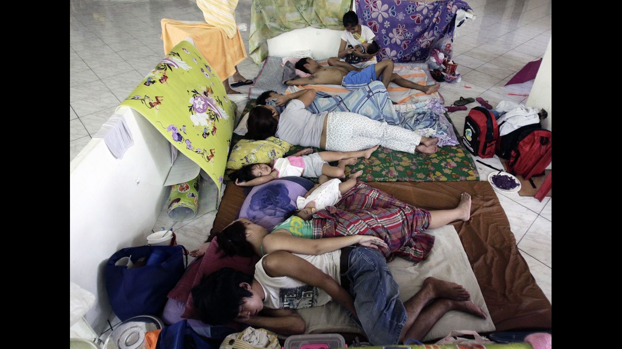 Flood victims rest in an evacuation center after their houses were flooded in San Juan.