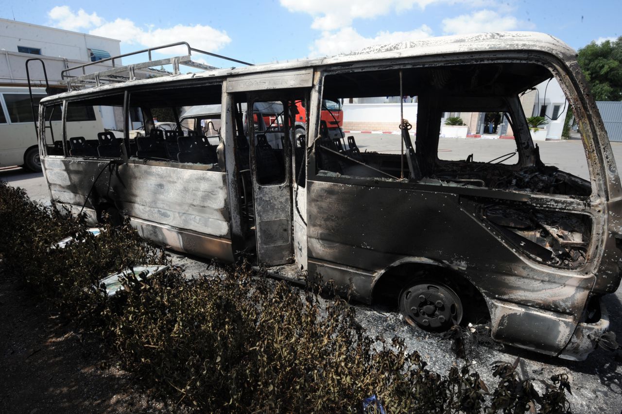 A burned bus sits in the grounds of the American school in Tunis on Saturday.