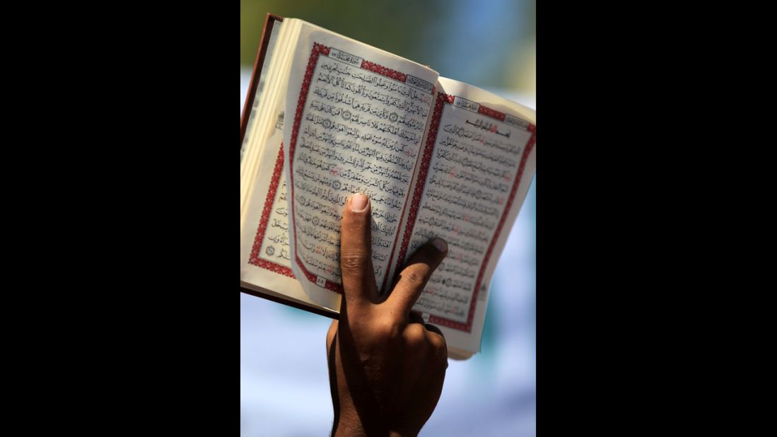 A Jordanian protester holds an Islamic book near the U.S. Embassy in Amman, Jordan, on Friday. Hundreds of members of Jordanian Salafi Movement gathered after Friday noon prayers in protest of a controversial anti-Islam film.